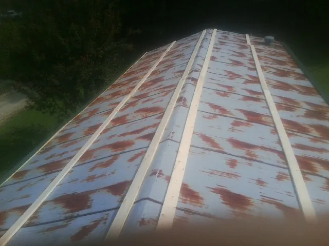 Rusted metal roof panels with new wood purlins before replacement — Storm Damage Roof Repair in New Canaan by Roofing Brothers