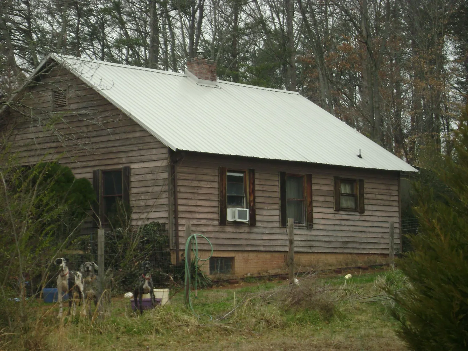 White metal roof on an old wood sided farmhouse, from a Metal Roof Installation job in New Canaan